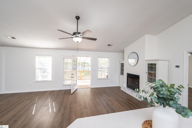 living room featuring ceiling fan and dark hardwood / wood-style floors