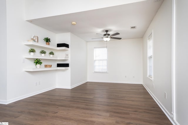 unfurnished living room featuring ceiling fan, dark hardwood / wood-style flooring, and plenty of natural light