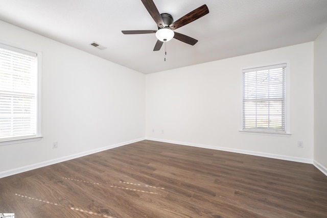 spare room featuring ceiling fan and dark hardwood / wood-style floors