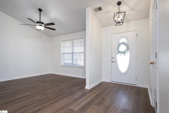 entrance foyer with lofted ceiling, dark hardwood / wood-style flooring, ceiling fan with notable chandelier, and plenty of natural light