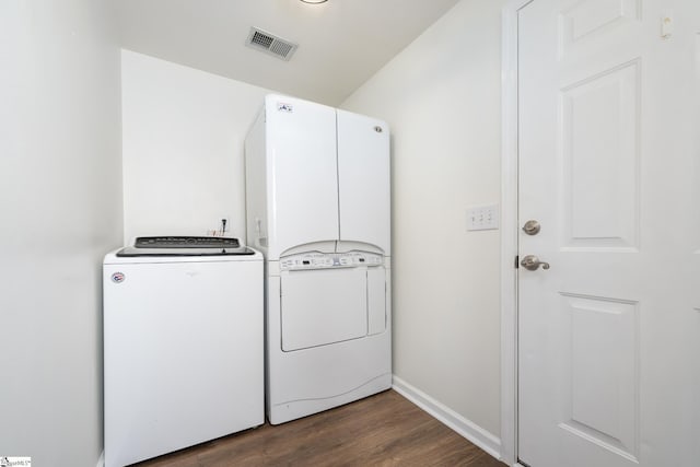 washroom featuring washing machine and dryer and dark hardwood / wood-style flooring