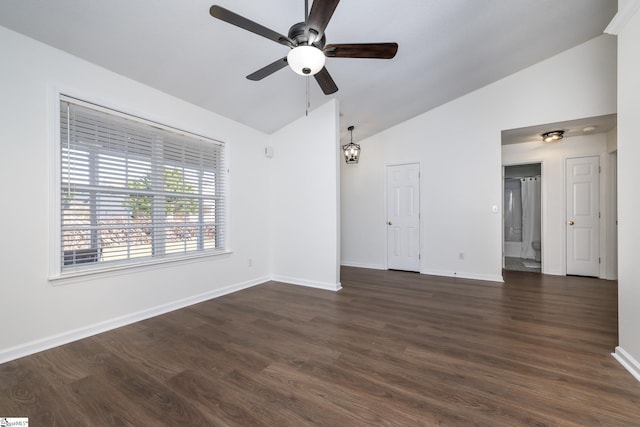 spare room with ceiling fan, vaulted ceiling, and dark hardwood / wood-style floors