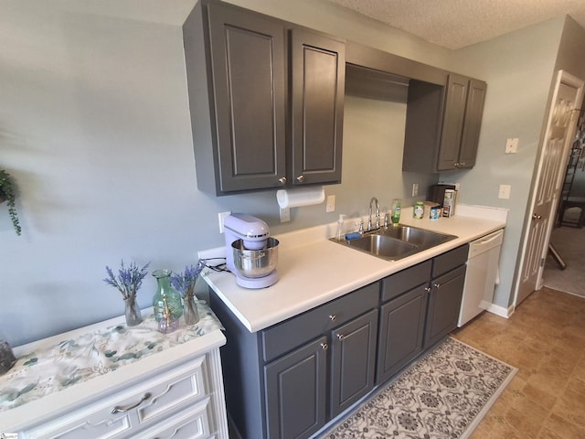 kitchen featuring a textured ceiling, dishwasher, and sink