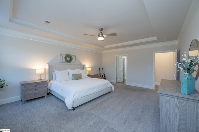 carpeted bedroom with ceiling fan, crown molding, and a raised ceiling