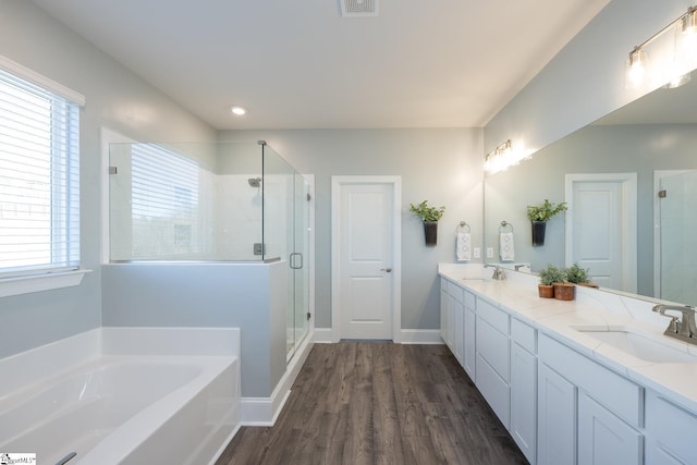 bathroom with plenty of natural light, hardwood / wood-style floors, vanity, and independent shower and bath