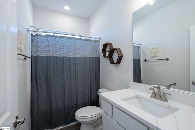 bathroom with toilet and vanity