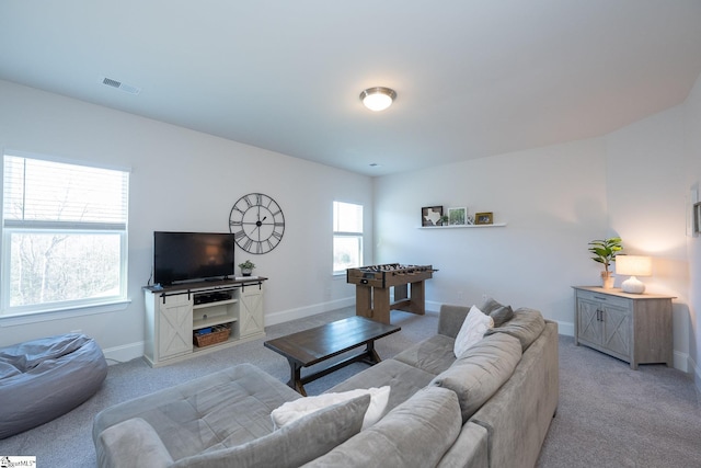 carpeted living room featuring plenty of natural light