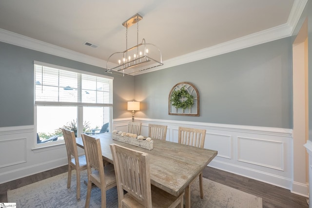 dining space with a chandelier, ornamental molding, and plenty of natural light