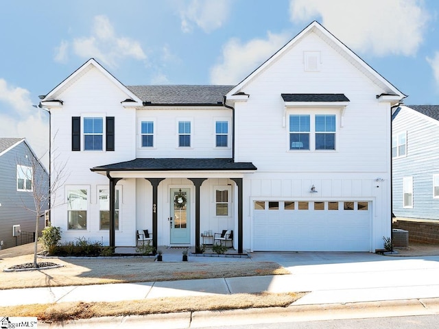 view of front of property featuring central AC unit, a garage, and a porch