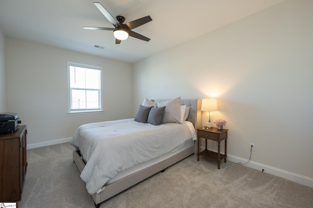 bedroom with ceiling fan and light carpet