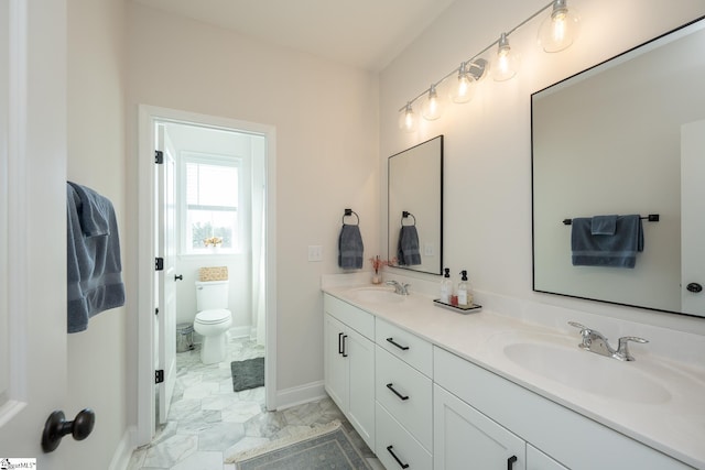 bathroom featuring toilet and vanity