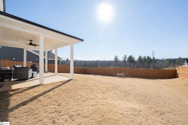 view of yard featuring ceiling fan and a patio