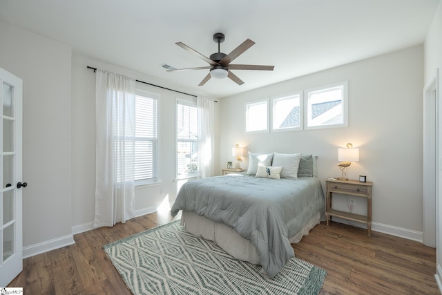 bedroom with ceiling fan and dark hardwood / wood-style flooring