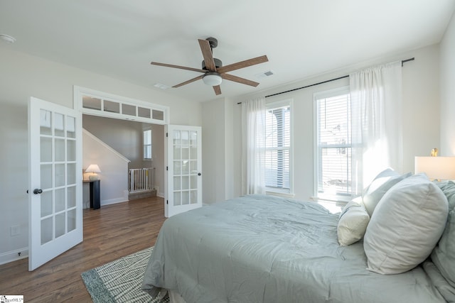 bedroom featuring ceiling fan, french doors, and dark hardwood / wood-style flooring