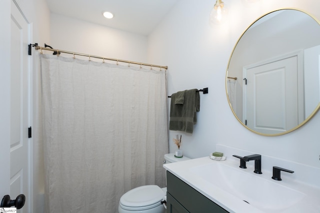 bathroom featuring toilet, vanity, and a shower with shower curtain