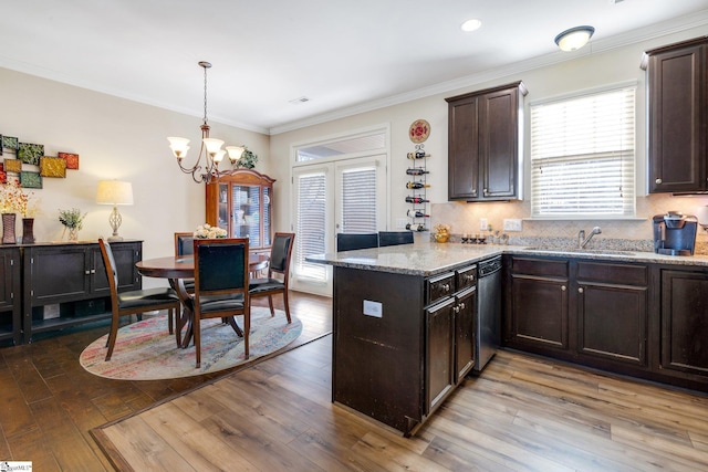 kitchen with hardwood / wood-style flooring, sink, and an inviting chandelier