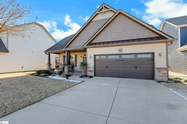 craftsman inspired home featuring a garage and a porch