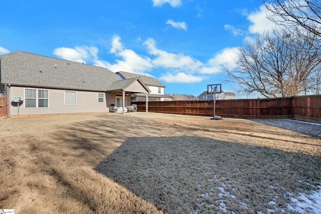 back of property with a patio area and a yard