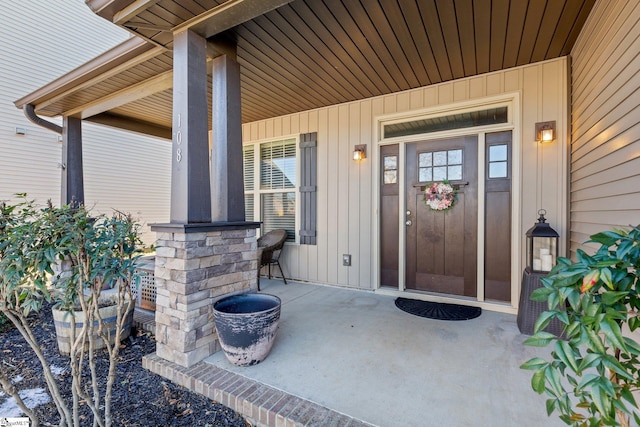 view of exterior entry with covered porch