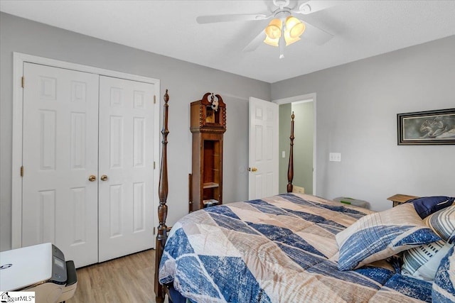 bedroom with ceiling fan, a closet, and light wood-type flooring