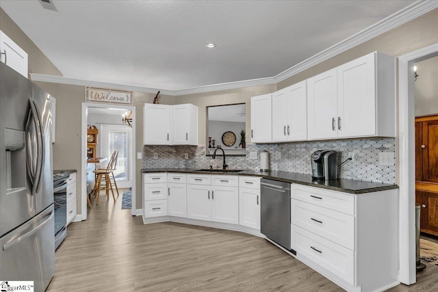 kitchen with light wood-type flooring, appliances with stainless steel finishes, white cabinetry, and sink