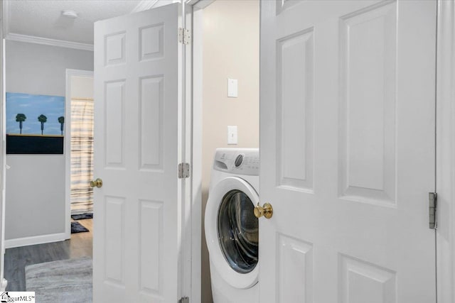 laundry room featuring a textured ceiling, ornamental molding, hardwood / wood-style floors, and washer / clothes dryer