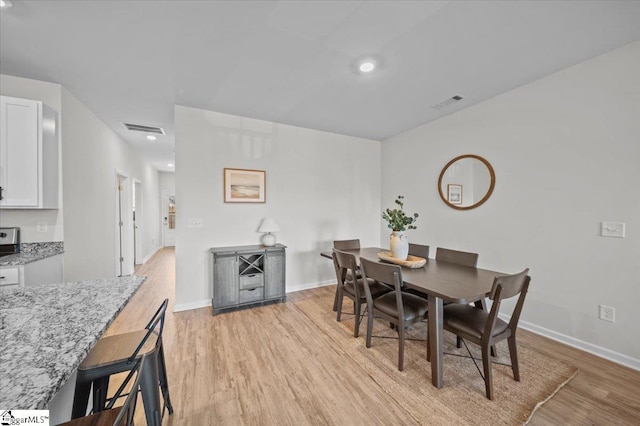 dining space featuring light hardwood / wood-style floors