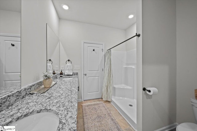 bathroom with toilet, vanity, and curtained shower