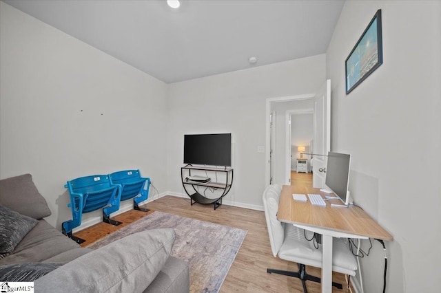 home office with light hardwood / wood-style flooring