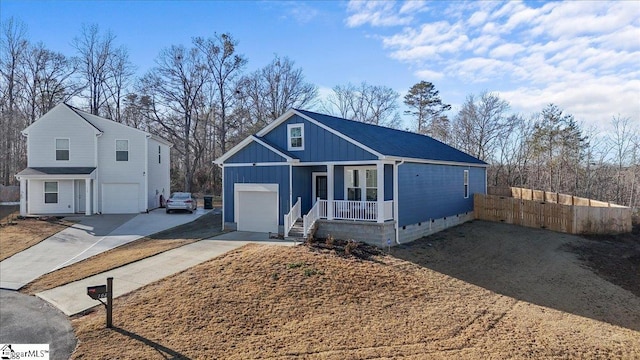 view of front facade featuring covered porch and a garage