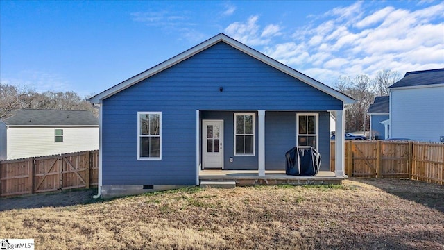 rear view of property featuring a yard