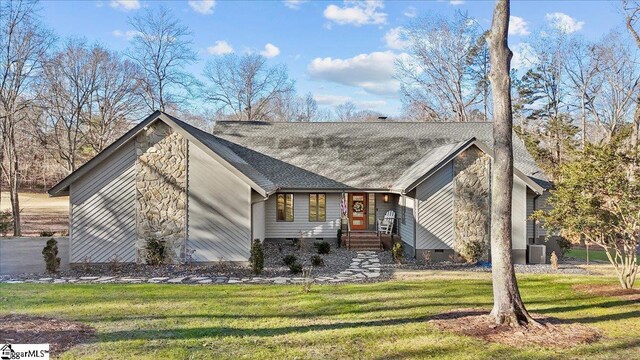 view of front of home with a front lawn and central AC unit