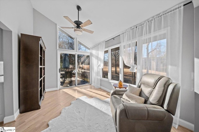 sunroom featuring ceiling fan and vaulted ceiling