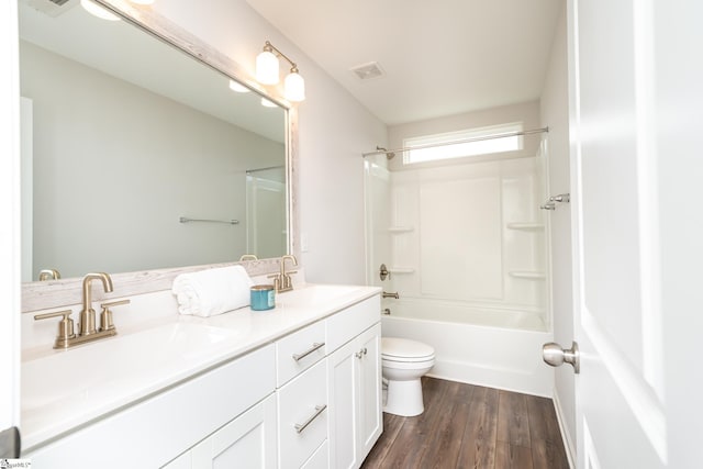 full bathroom with toilet, hardwood / wood-style floors, shower / washtub combination, and vanity