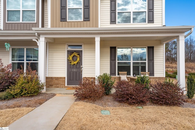 view of exterior entry featuring a porch