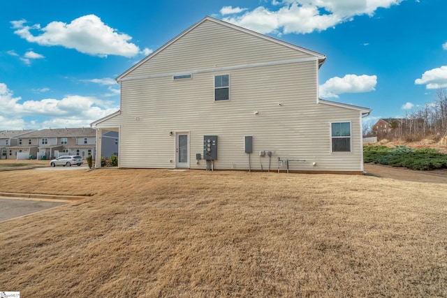 back of property with a lawn