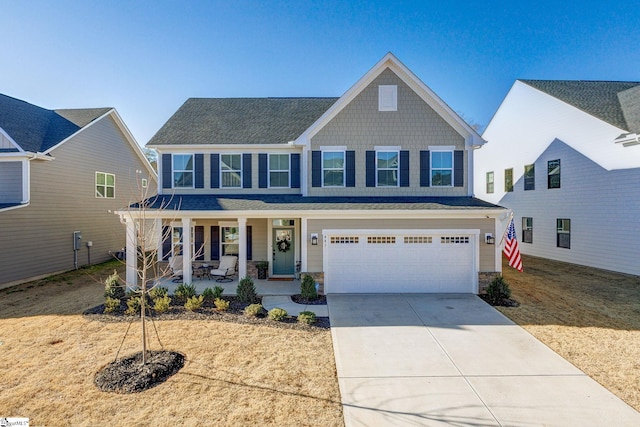 view of front of property with covered porch and a garage