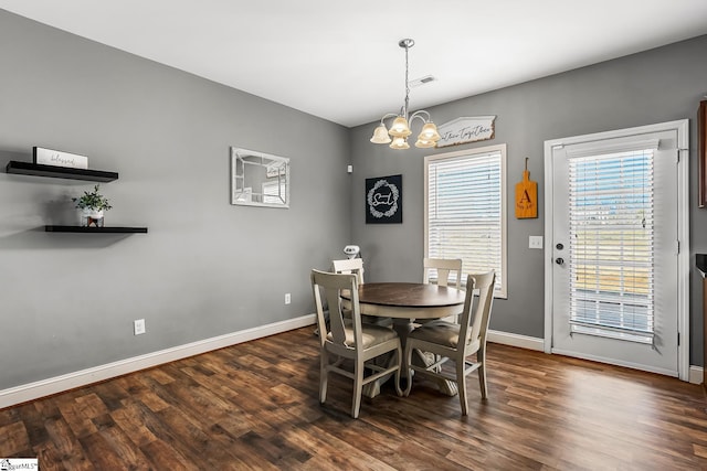 dining room featuring a chandelier and dark hardwood / wood-style flooring