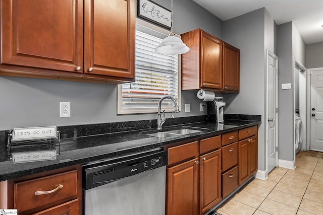 kitchen featuring decorative light fixtures, dishwasher, dark stone countertops, sink, and light tile patterned flooring