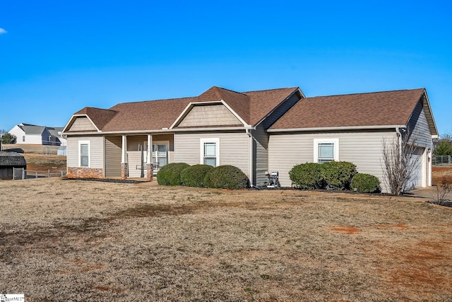 ranch-style home with covered porch and a front lawn