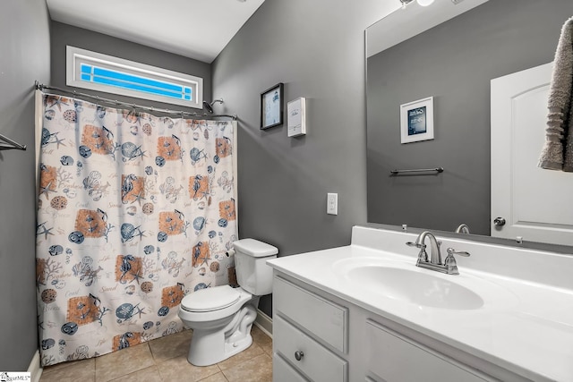 bathroom featuring toilet, walk in shower, tile patterned floors, and vanity