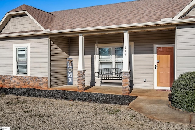 view of exterior entry with a porch