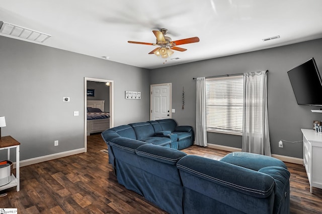 living room with dark wood-type flooring and ceiling fan