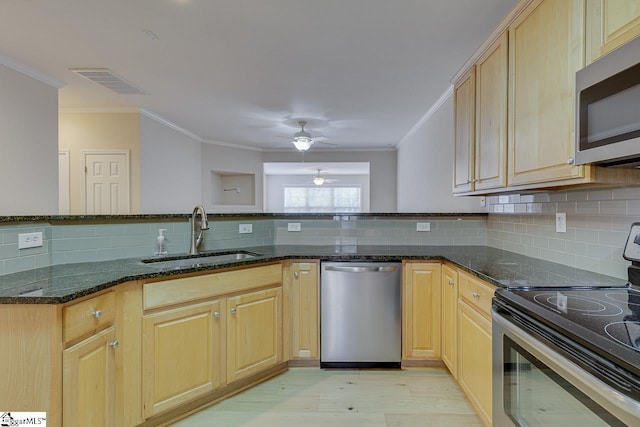 kitchen with ceiling fan, sink, dark stone countertops, and stainless steel appliances