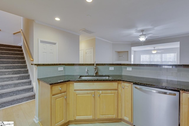 kitchen with ceiling fan, dishwasher, light hardwood / wood-style floors, sink, and dark stone counters