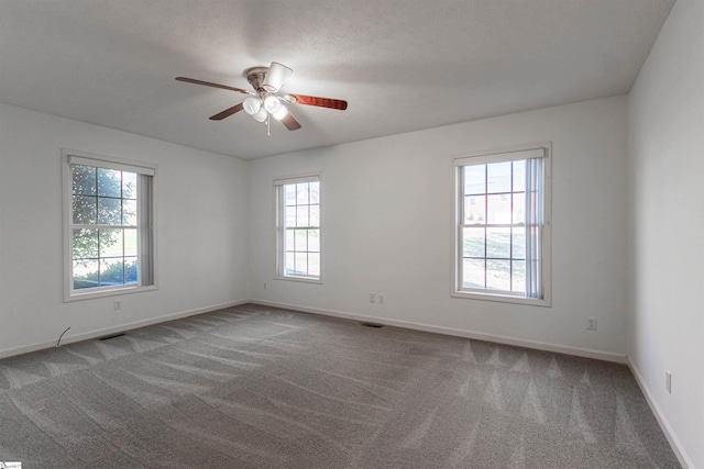 carpeted empty room featuring ceiling fan