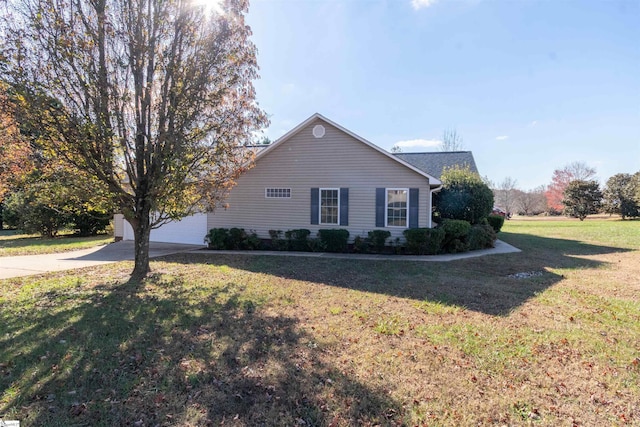 view of side of home featuring a garage and a lawn