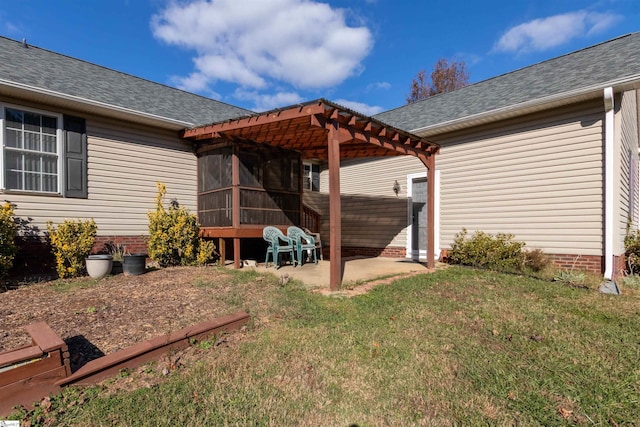 rear view of property featuring a lawn, a pergola, a patio area, and a sunroom