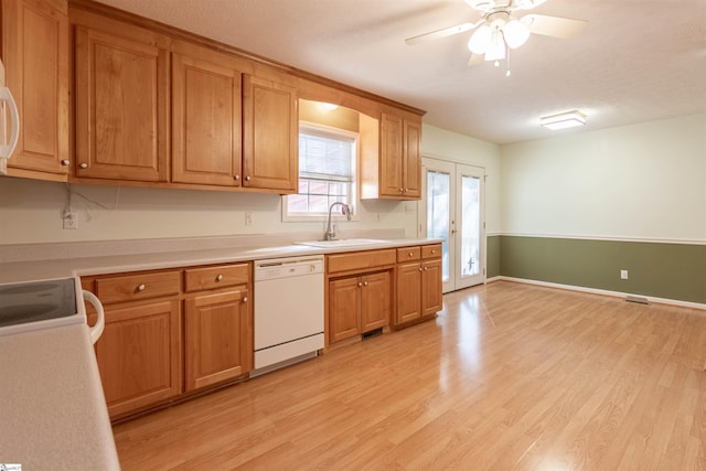 kitchen featuring french doors, ceiling fan, sink, white dishwasher, and light hardwood / wood-style flooring