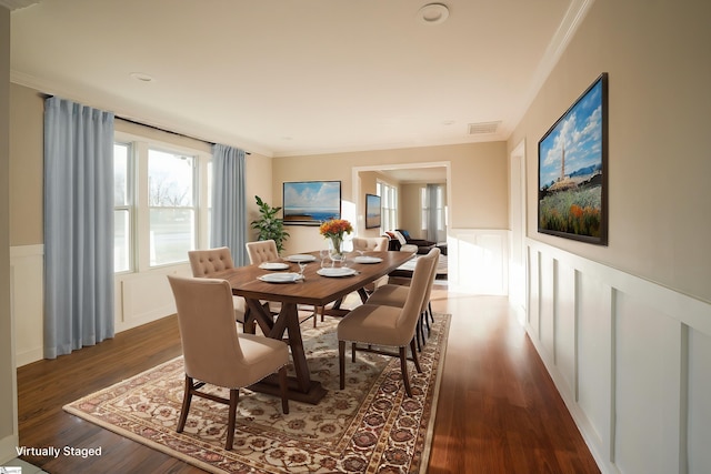 dining room with dark hardwood / wood-style floors and crown molding